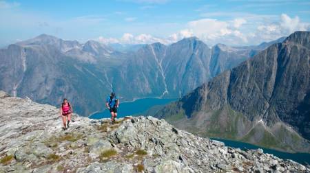 På vei ned mot Svartvassbu. Bak oss ligger Eikesdalsvatnet omkranset av fra venstre Goksøyra, Skjorta, Litlskjorta, Trondskjortetind og Fløtatind. På bildet: Kari og Bård. Foto: Ola Hovdenak